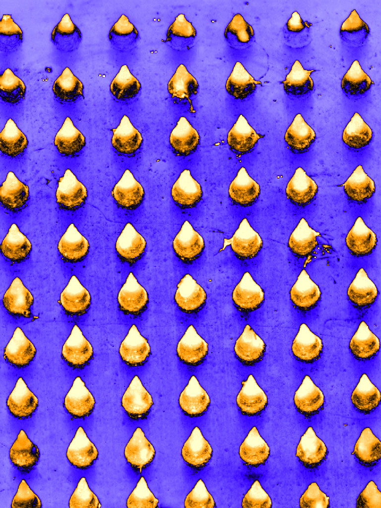 grid of rounded gold cones on an indigo background