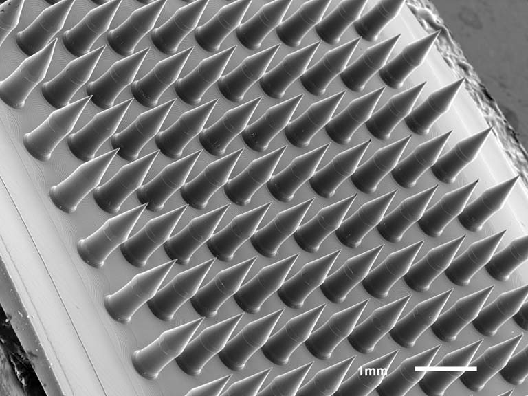 conical microneedles on a titled base